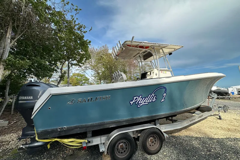 Slide: The Image of 2011 Sailfish 2660 CC boat on trailer, featuring Yamaha engine, named "Phyllis 2". - 4