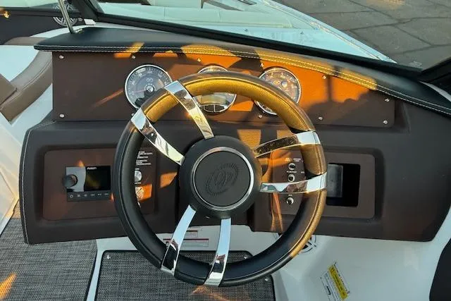 Slide: The Image of Steering wheel and dashboard of a 2022 Cobalt CS22 boat, featuring modern controls and gauges. - 13