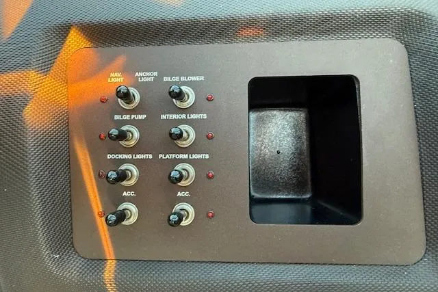 Slide: The Image of Control panel of a 2022 Cobalt CS22 boat with various switches. - 19