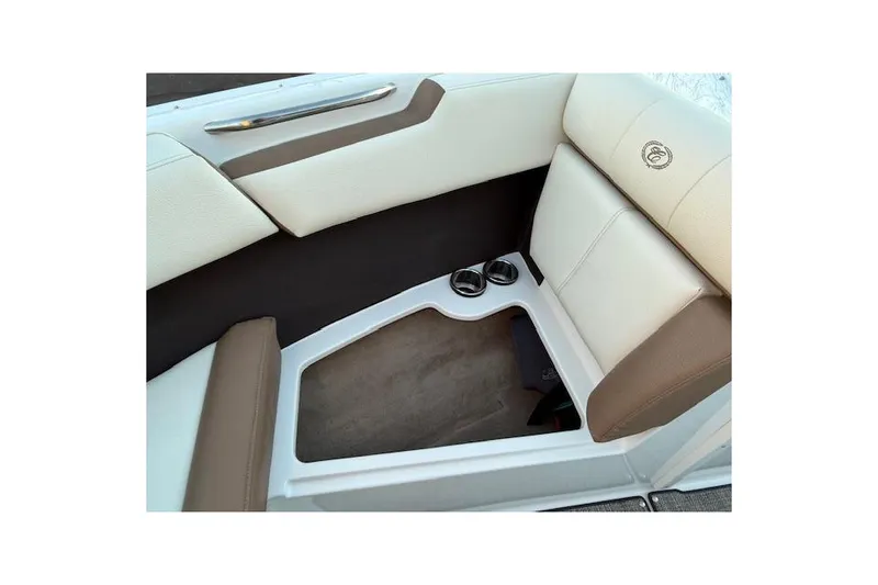 Slide: The Image of 2022 Cobalt CS22 boat interior with beige and brown seating, featuring cup holders. - 22