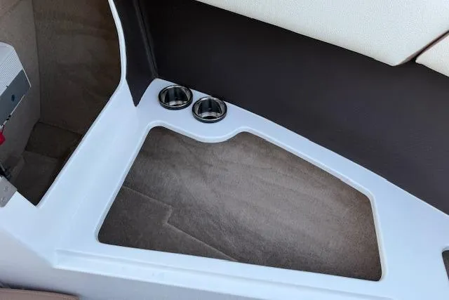 Slide: The Image of Interior of 2022 Cobalt CS22 boat featuring cup holders and carpeted flooring. - 24