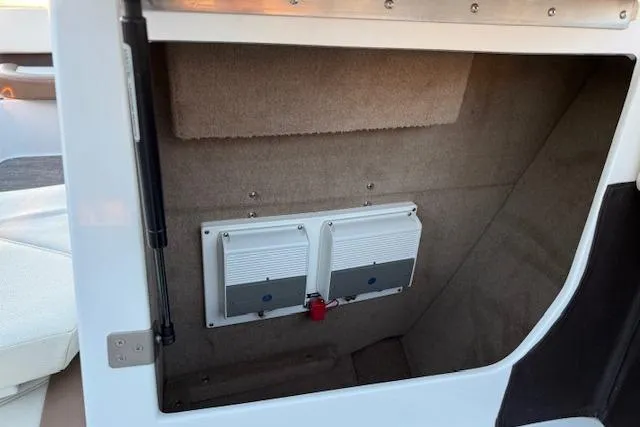 Slide: The Image of 2022 Cobalt CS22 boat storage compartment with electronic components. - 25