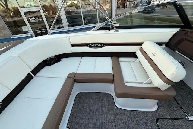 Slide: The Image of 2022 Cobalt CS22 boat interior with white and brown seating, showcasing luxury design. - 28