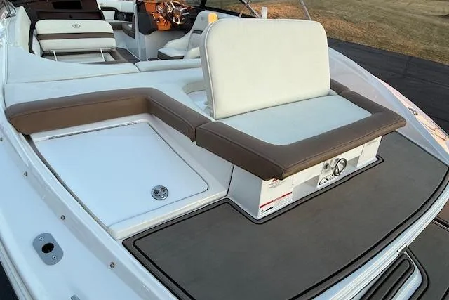 Slide: The Image of 2022 Cobalt CS22 boat interior with white and brown seating, sleek design. - 35