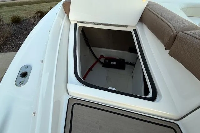 Slide: The Image of 2022 Cobalt CS22 boat storage compartment with open hatch, showcasing interior space and seating. - 36