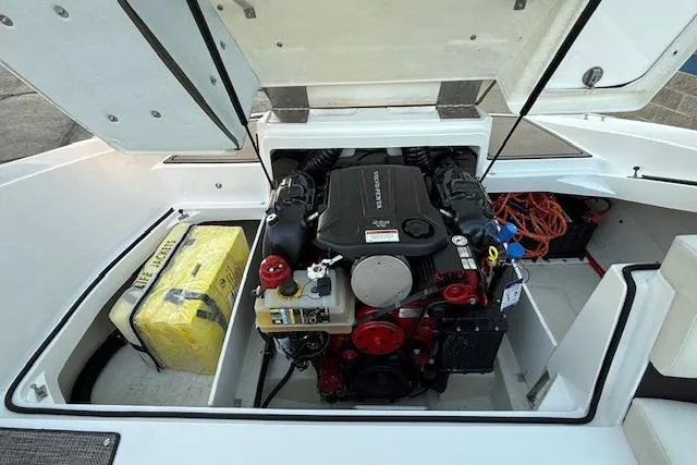 Slide: The Image of 2022 Cobalt CS22 boat engine compartment with visible engine and storage area. - 37