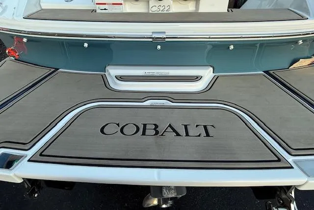 Slide: The Image of 2022 Cobalt CS22 boat stern with branded swim platform and teal hull. - 41