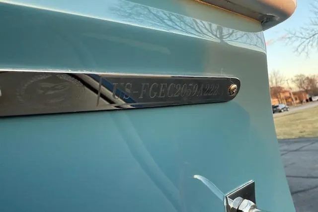 Slide: The Image of 2022 Cobalt CS22 boat with identification plate, light blue exterior, parked outdoors. - 42