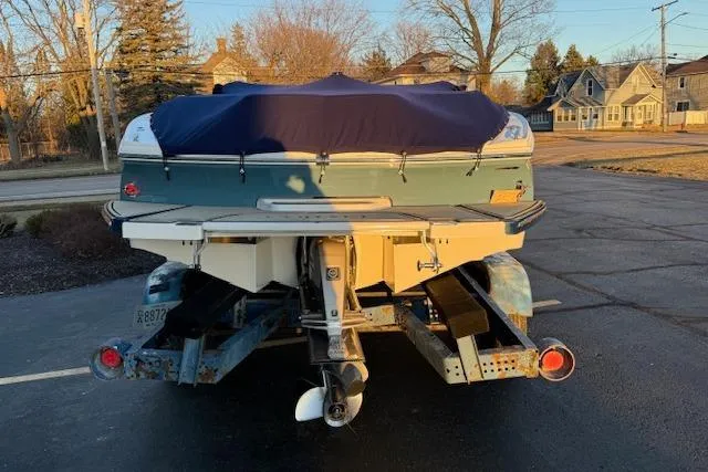 Slide: The Image of 2022 Cobalt CS22 boat on trailer, covered, parked in residential area. - 6
