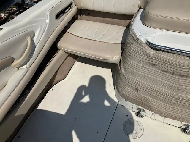 Slide: The Image of 1997 Sea Ray 190 Bow Rider interior with white and beige seating. - 11