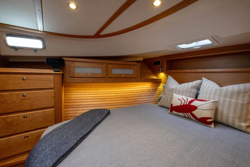 Slide: The Image of Luxurious cabin interior of 2026 Sabre 45 Salon Express with wooden finish and cozy bedding. - 16