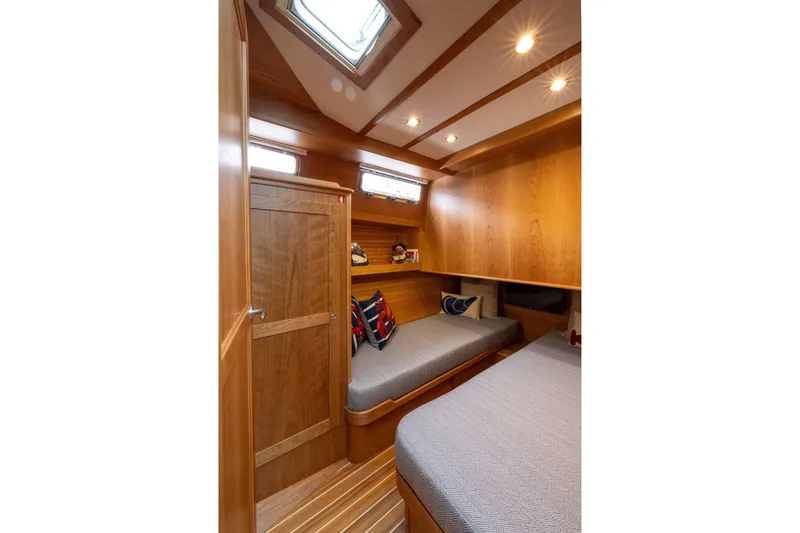 Slide: The Image of Luxurious wooden interior of 2026 Sabre 45 Salon Express yacht cabin with cozy bedding. - 19