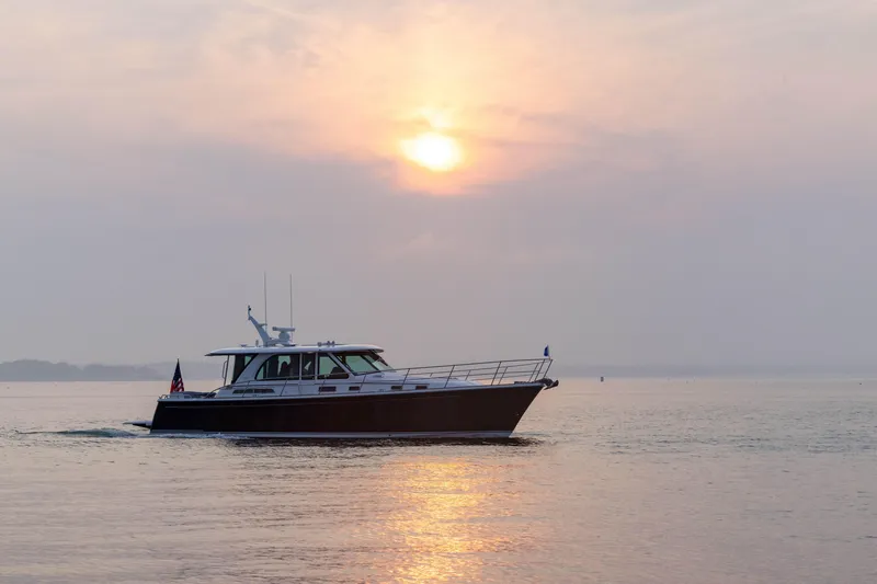 Slide: The Image of 2026 Sabre 45 Salon Express yacht cruising at sunset on calm waters. - 5