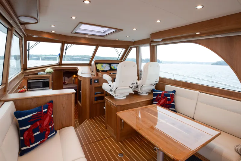 Slide: The Image of Interior of 2026 Sabre 45 Salon Express yacht with luxurious seating and navigation area. - 9