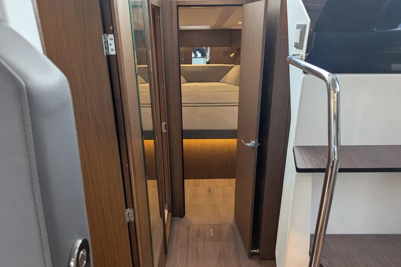 Slide: The Image of Interior view of 2024 Beneteau Antares 11, featuring modern wood finishes and cozy cabin space. - 11