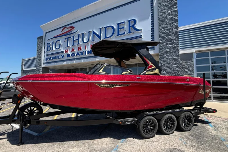 The Image of 2026 Tigé Ultré 25ZX boat in vibrant red at Big Thunder Marine dealership. - 1