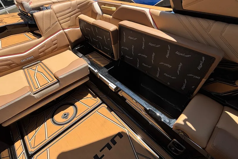 Slide: The Image of 2026 Tigé Ultré 25ZX boat interior with luxurious tan seating and storage compartments. - 26