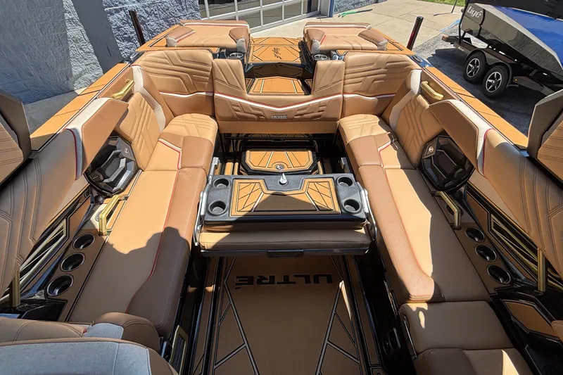 Slide: The Image of Luxurious interior of 2026 Tigé Ultré 25ZX boat with tan leather seating and cup holders. - 27