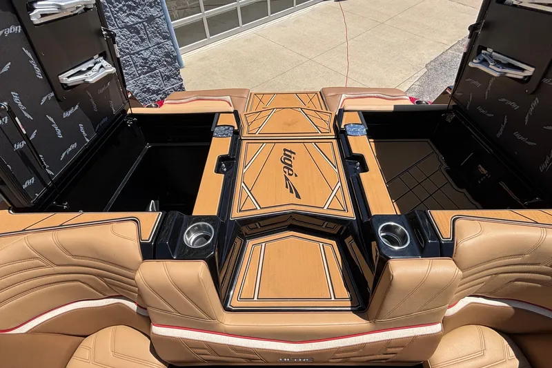 Slide: The Image of 2026 Tigé Ultré 25ZX boat interior with tan leather seats and storage compartments. - 31