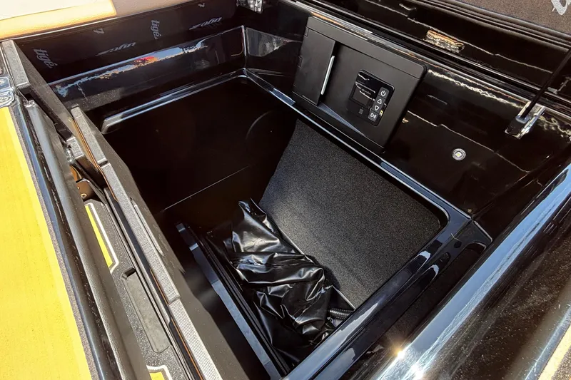 Slide: The Image of Storage compartment in 2026 Tigé Ultré 25ZX boat, featuring sleek black interior design. - 33