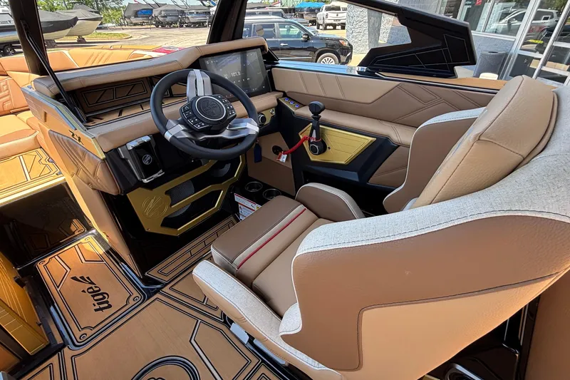 Slide: The Image of 2026 Tigé Ultré 25ZX boat interior with luxurious tan seating and advanced steering console. - 39