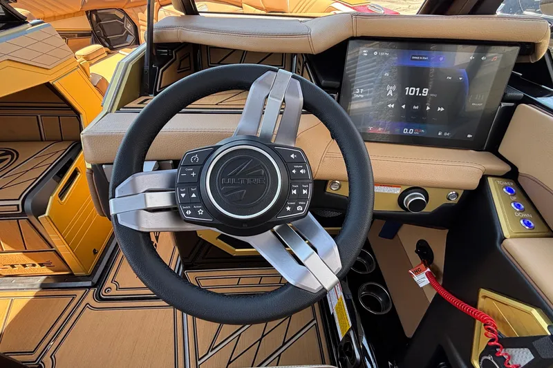 Slide: The Image of 2026 Tigé Ultré 25ZX boat interior with advanced steering and touchscreen display. - 47