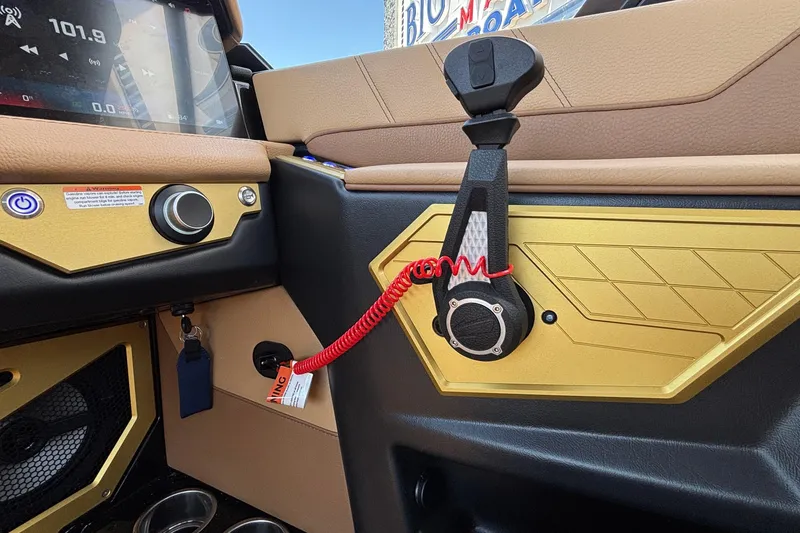 Slide: The Image of Interior of 2026 Tigé Ultré 25ZX boat, featuring control panel and throttle lever. - 49