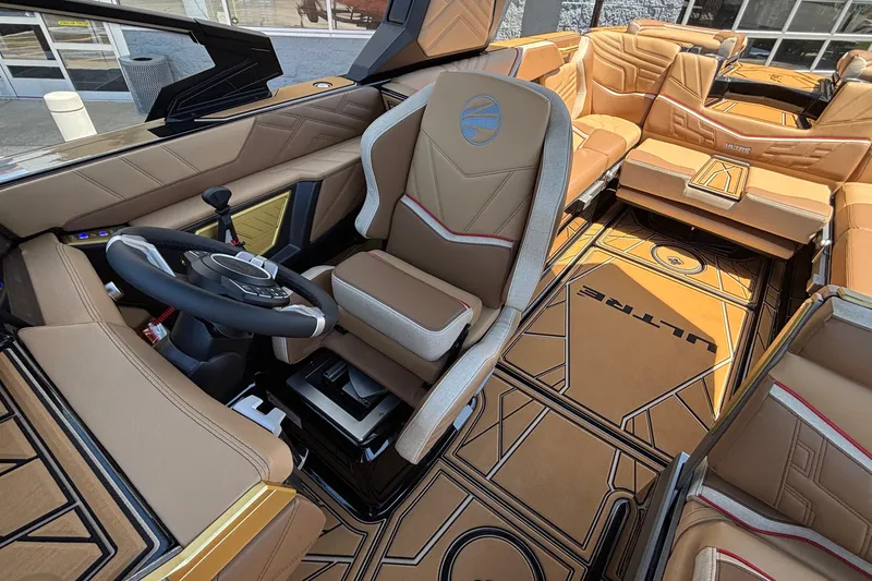 Slide: The Image of Interior of 2026 Tigé Ultré 25ZX boat with luxurious tan seating and modern steering. - 51