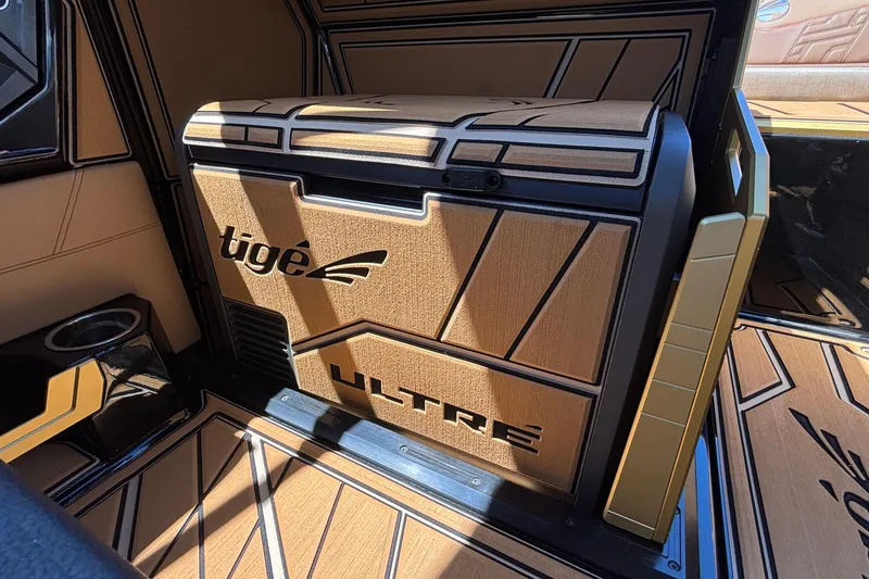 Slide: The Image of 2026 Tigé Ultré 25ZX interior with stylish wood paneling and integrated cup holder. - 53