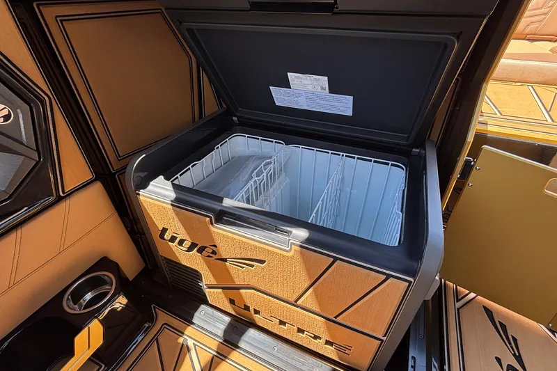 Slide: The Image of Open cooler in 2026 Tigé Ultré 25ZX boat, showcasing spacious interior design. - 55