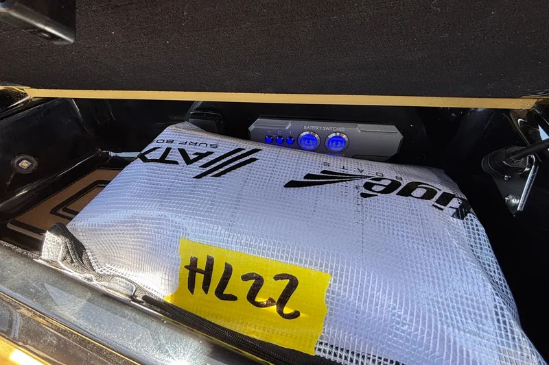 Slide: The Image of Storage compartment of 2026 Tigé Ultré 25ZX with battery switches and surf bag. - 57