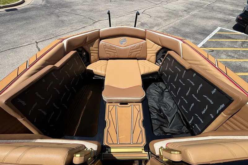 Slide: The Image of 2026 Tigé Ultré 25ZX boat interior with tan leather seating and storage compartments. - 63