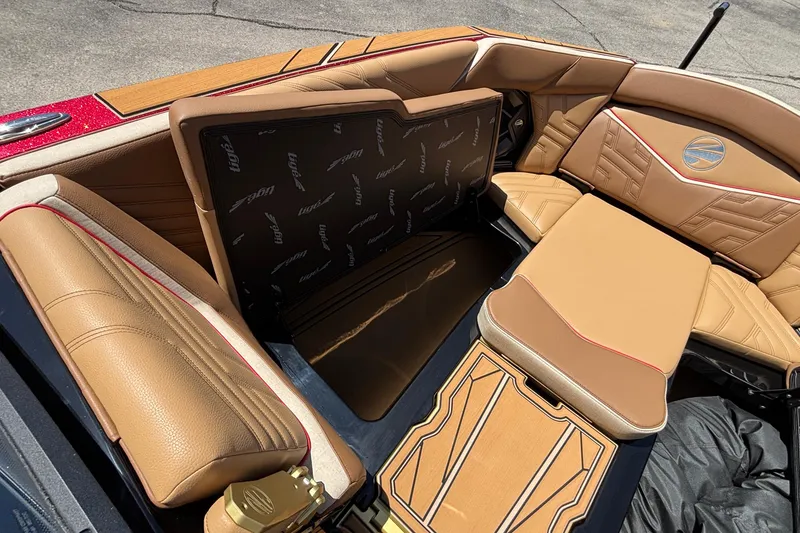 Slide: The Image of 2026 Tigé Ultré 25ZX boat interior with tan leather seating and storage compartment. - 64
