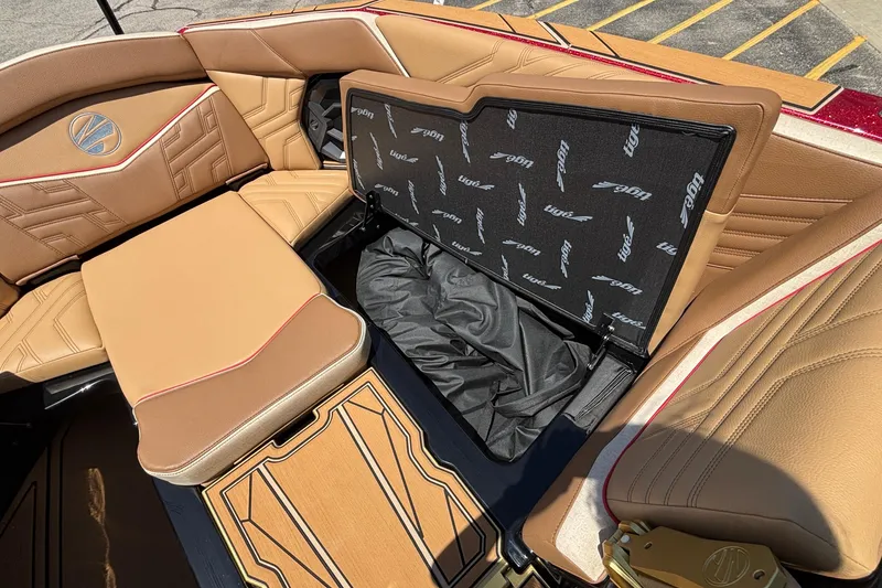 Slide: The Image of 2026 Tigé Ultré 25ZX boat interior with tan leather seating and storage compartment. - 65