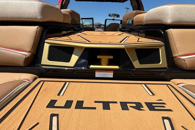 Slide: The Image of 2026 Tigé Ultré 25ZX boat interior with tan seating and stylish deck design. - 9
