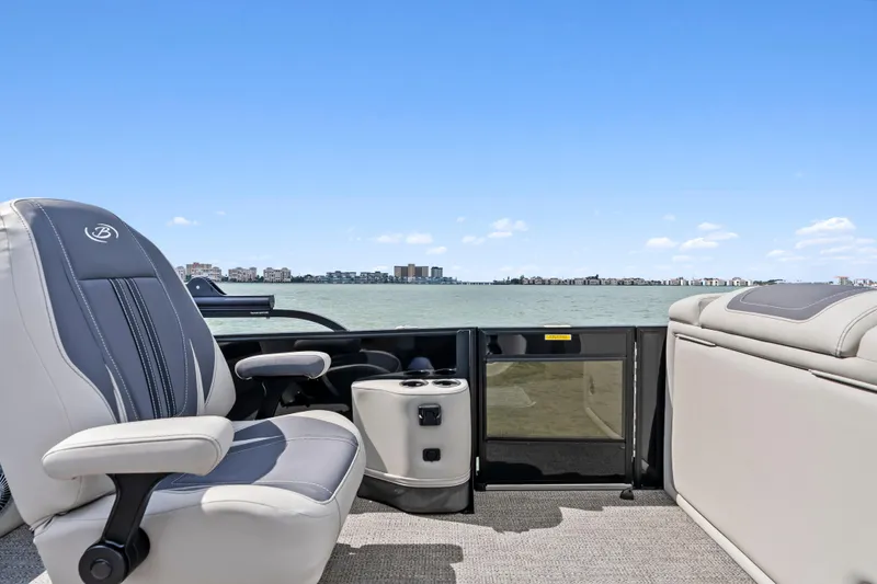 Slide: The Image of 2025 Barletta Corsa 23UC pontoon boat interior with luxurious seating and scenic water view. - 11