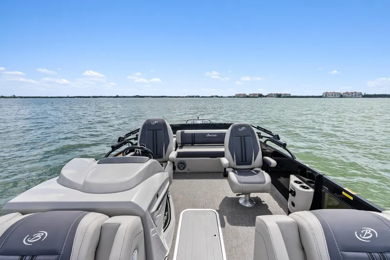 Slide: The Image of 2025 Barletta Corsa 23UC pontoon boat interior on a serene lake. - 12