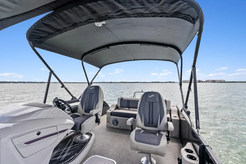 Slide: The Image of 2025 Barletta Corsa 23UC pontoon boat interior with canopy on open water. - 15
