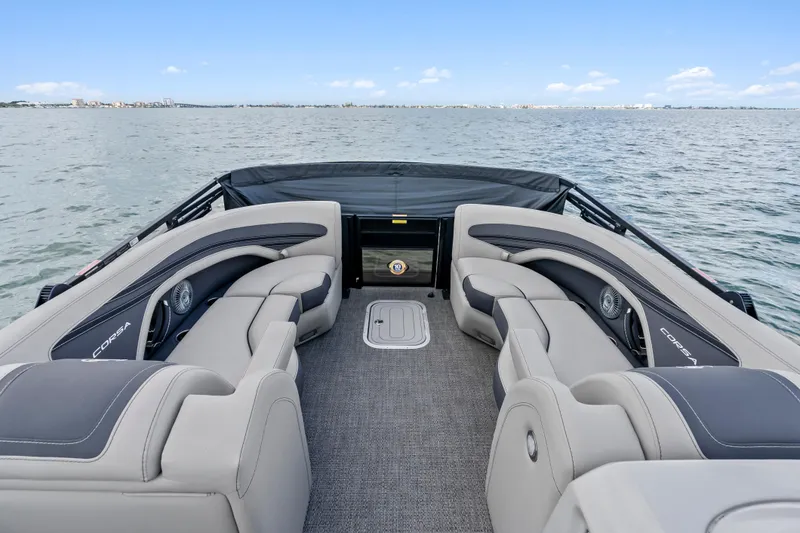 Slide: The Image of 2025 Barletta Corsa 23UC pontoon boat interior with luxurious seating on open water. - 6
