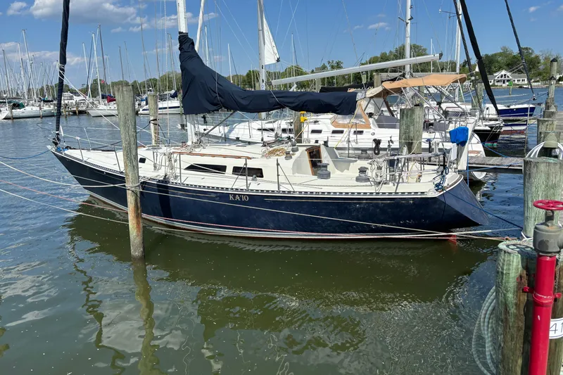 The Image of 1980 C&C 40-2 sailboat docked at a marina under a clear blue sky. - 0