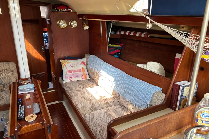 Slide: The Image of Cozy interior of a 1980 C&C 40-2 sailboat with wooden furnishings and nautical decor. - 12