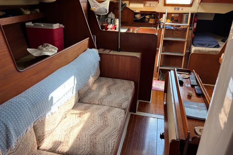 Slide: The Image of Interior of a 1980 C&C 40-2 sailboat with cozy seating and wooden finishes. - 15