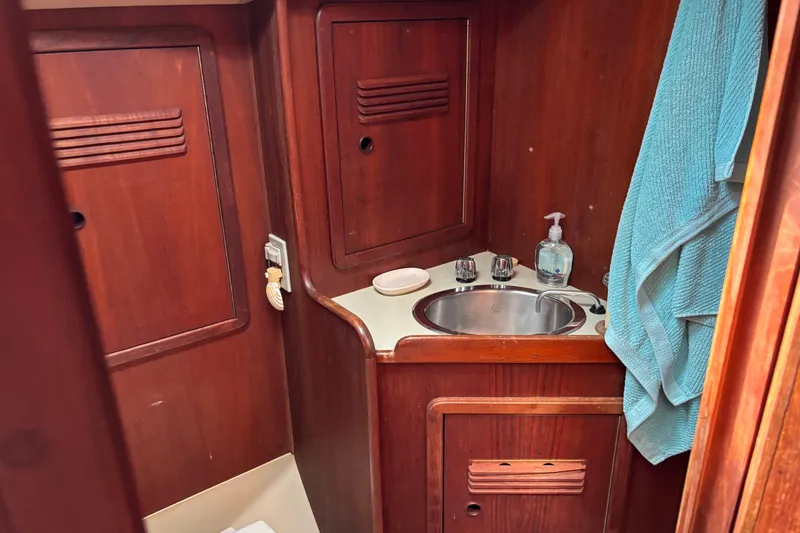 Slide: The Image of 1980 C&C 40-2 yacht bathroom with wooden cabinetry and stainless steel sink. - 19