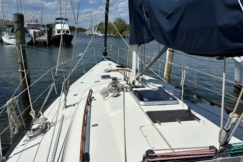 Slide: The Image of Sailboat docked at marina, C&C 40-2 model, 1980, with clear sky and calm water. - 2