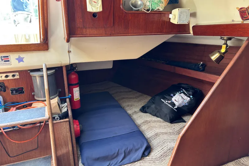 Slide: The Image of Cozy cabin interior of 1980 C&C 40-2 sailboat with fire extinguisher and storage. - 23