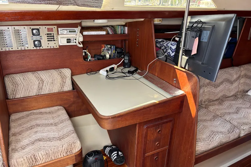 Slide: The Image of 1980 C&C 40-2 yacht interior with navigation station, seating, and electronics. - 25