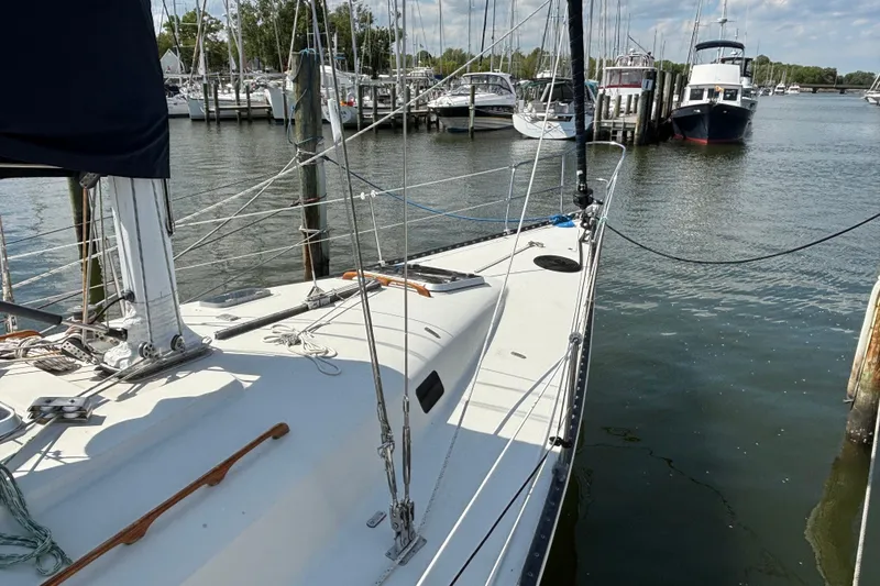 Slide: The Image of Sailboat docked in marina, C&C 40-2 model, 1980, surrounded by other boats. - 4