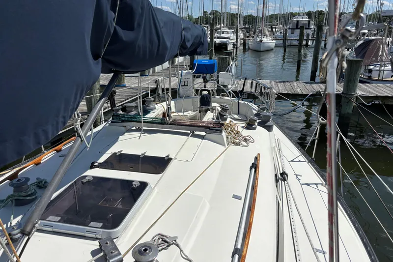 Slide: The Image of 1980 C&C 40-2 sailboat docked at marina, featuring deck and rigging details. - 6