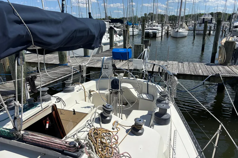Slide: The Image of 1980 C&C 40-2 sailboat docked at marina, surrounded by other boats. - 8
