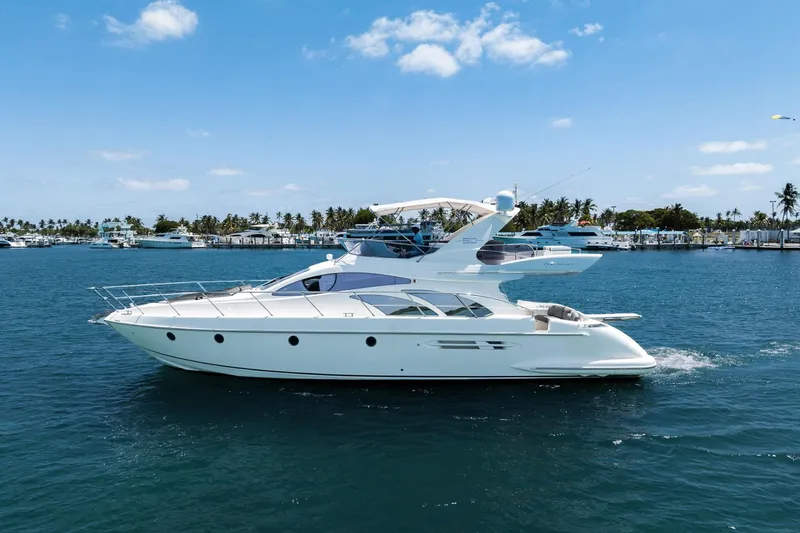 The Image of 2008 Azimut Fly 50 yacht cruising on a sunny day, with clear blue skies and calm waters. - 1